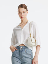 A lady wears a v-neck shirt.